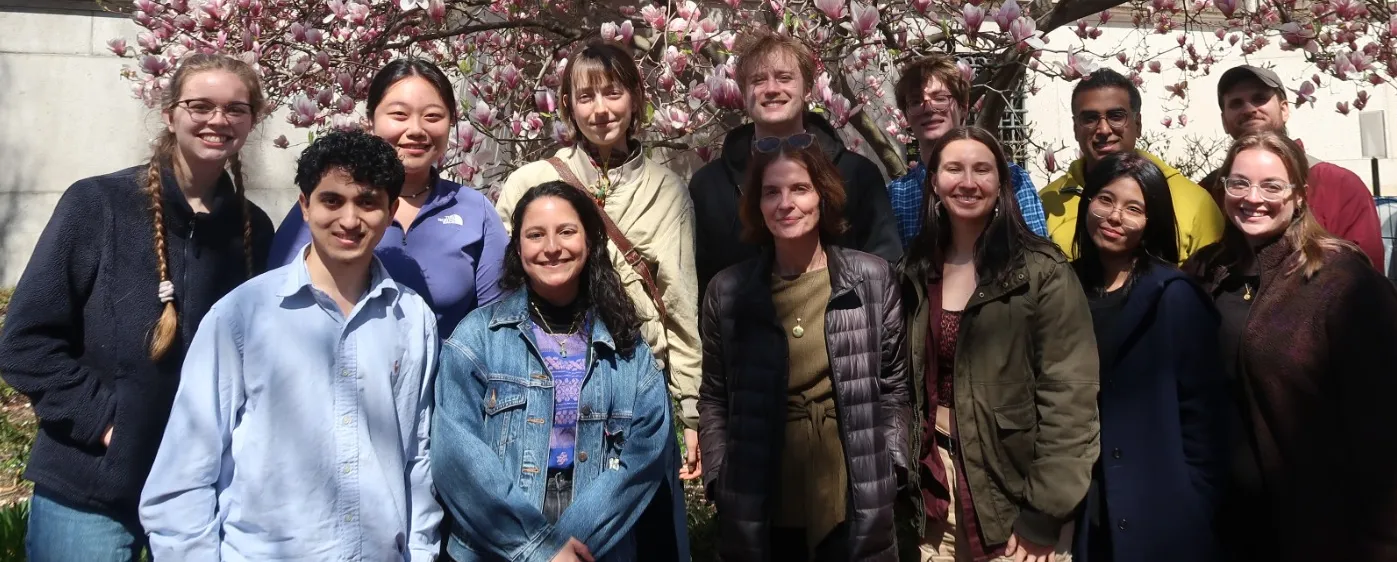 Group photo of the Uriarte Lab in front of a blooming Magnolia tree